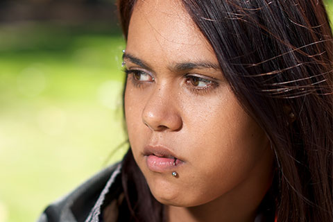 Young aboriginal adolescent girl looking away outside