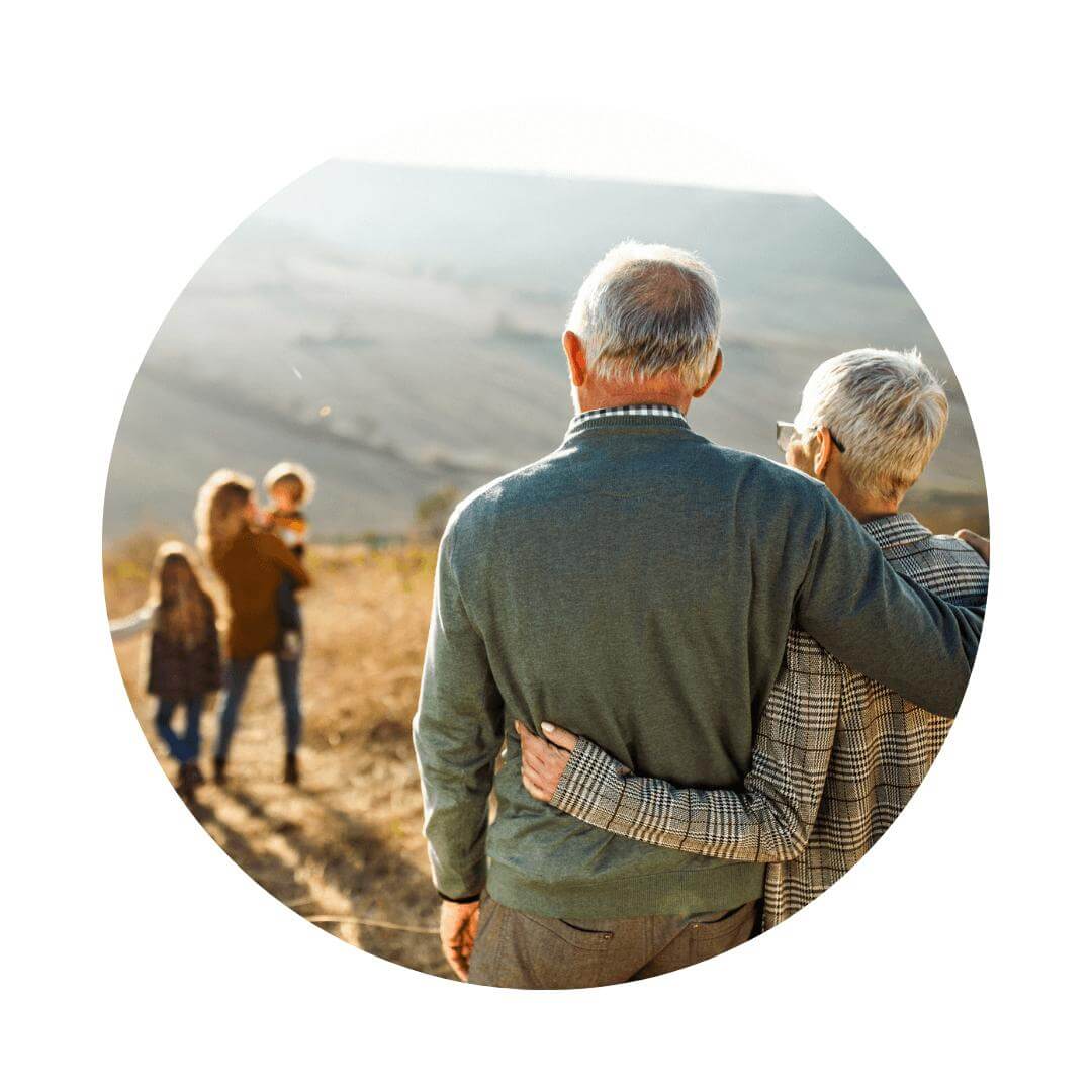 Grandparents looking into the distance as the next generation explore the country