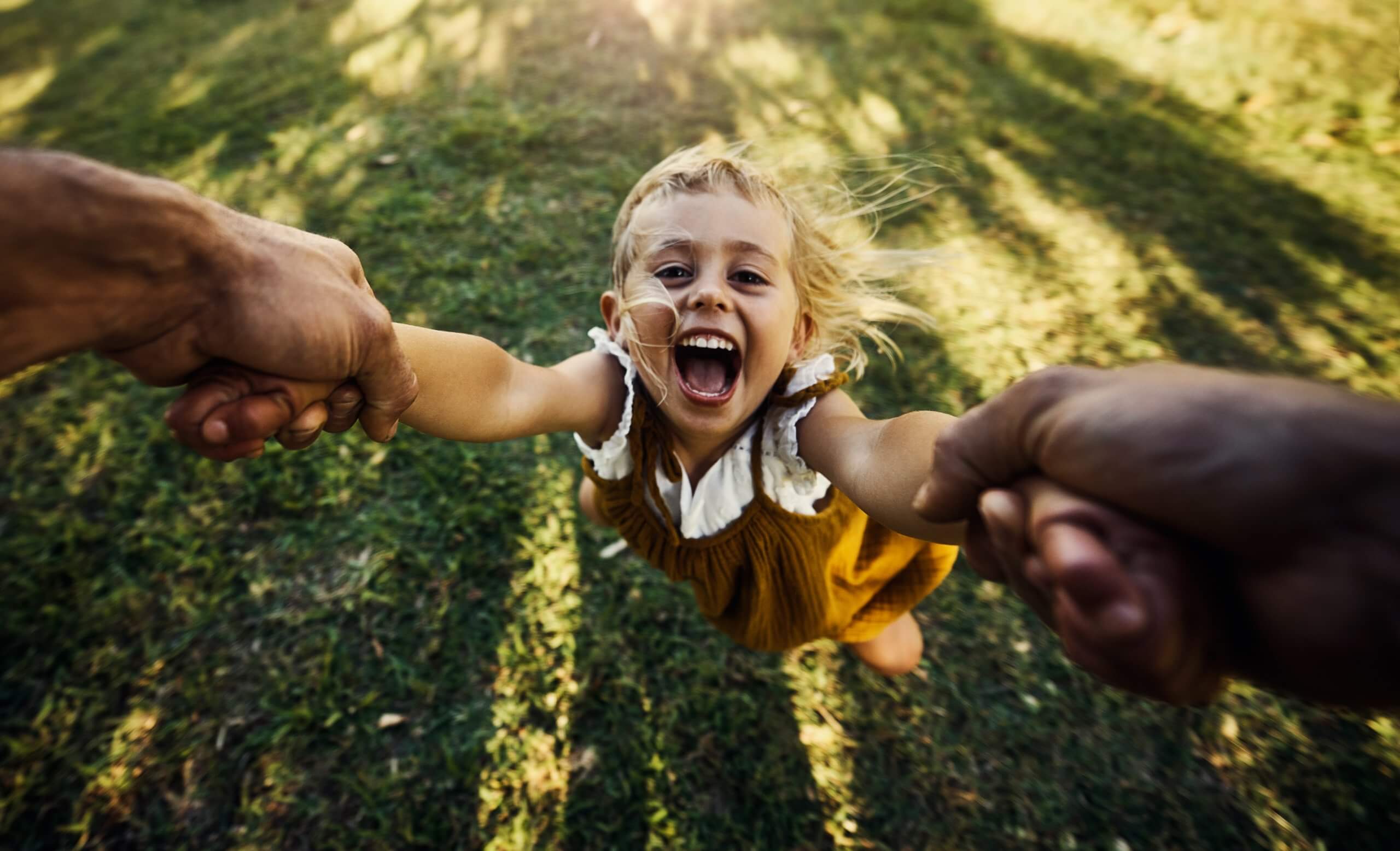 A child in foster care playing outside with her father
